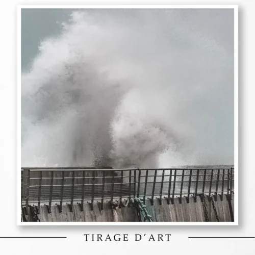 Giant wave breaking over the sea wall during a storm in Brittany